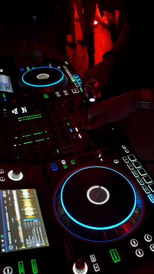 Close-up of DJ Zafyr mixing on illuminated DJ decks