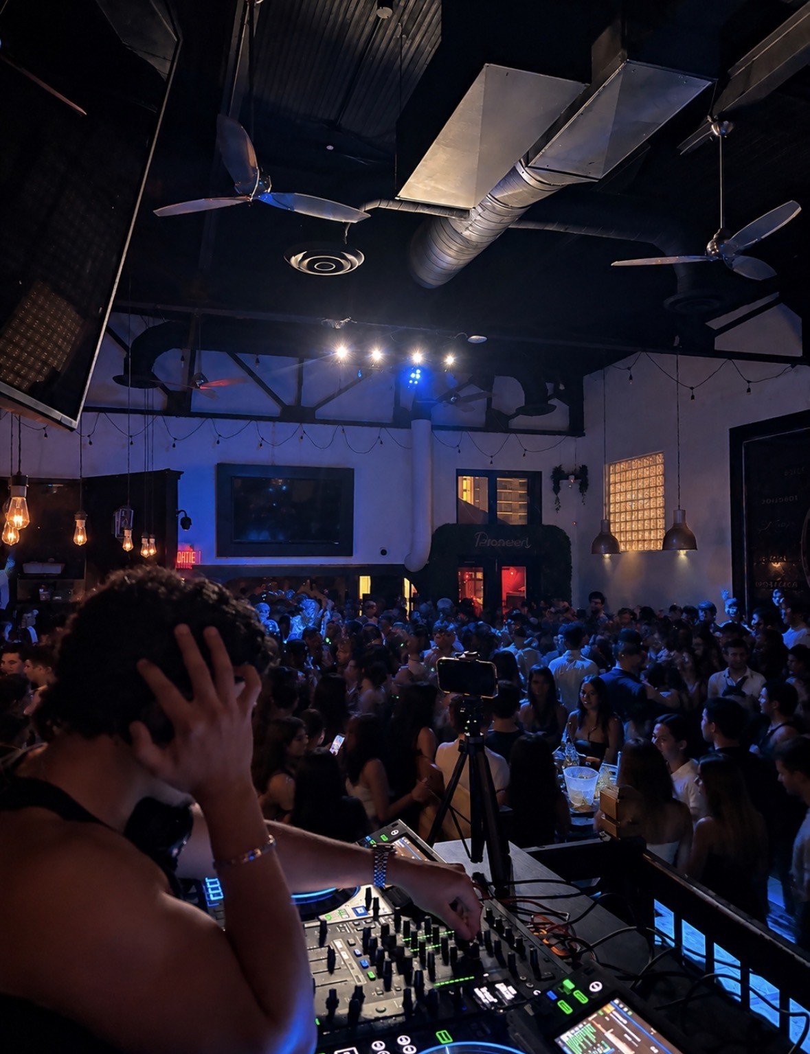 DJ Zafyr behind the decks with the crowd at his events
